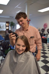 Adam taking the first swipe with the clippers to shave my head April 2, 2015
